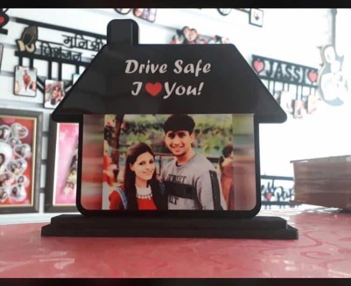 car dashboard photo frame with photo of friends or family with the text drive safe.