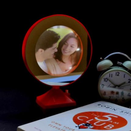 magic mirror photo frame with a book 5 am club and a alarm clock as a prop